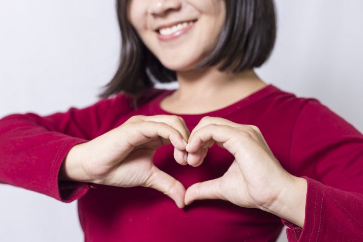 Woman doing a hand heart