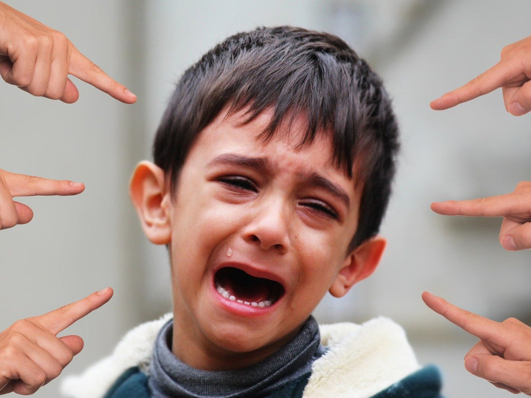 boy crying and being point at